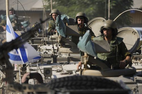 Israeli soldiers gather in a staging area near the border with Gaza Strip, in southern Israel Tuesday, Oct. 17, 2023. 