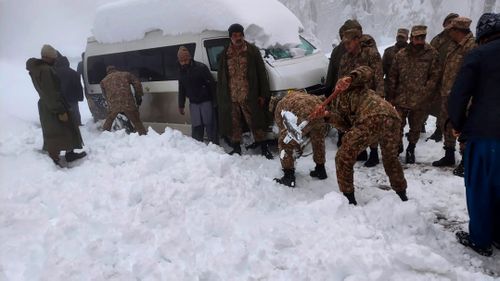In this photo provided by the Inter Services Public Relations, army troops take part in a rescue operation in a heavy snowfall-hit area in Murree, 45 km north of the capital of Islamabad, Pakistan.