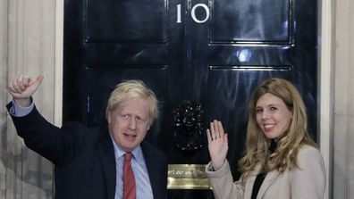 Friday, Dec. 13, 2019 file photo, Britain's Prime Minister Boris Johnson and his partner Carrie Symonds wave from the steps of number 10 Downing Street in London