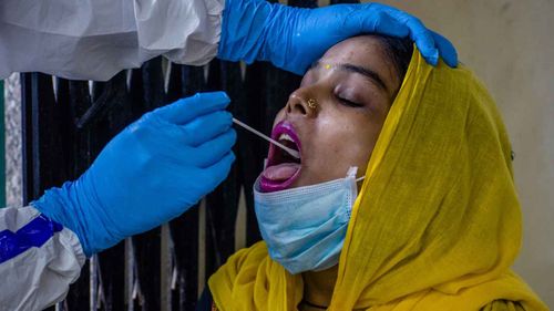 A woman gets a saliva test in New Delhi, India.