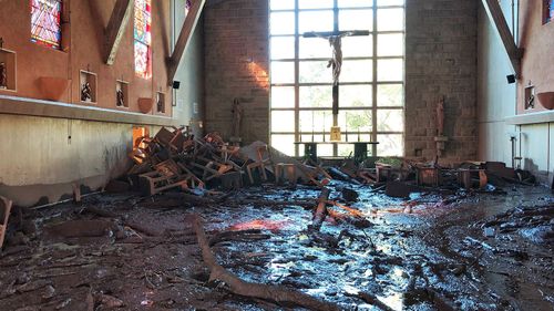 A handout photo made available by Santa Barbara County Fire Department shows damage from mudflow in the chapel at La Casa de Maria following the heavy rainfall. (Image: AAP)