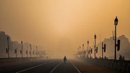 A man walked along Rajpath boulevard amid smoggy conditions in New Delhi, India. 