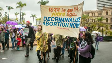 People are seen attending the March together for Choice rally in Brisbane last weekend.