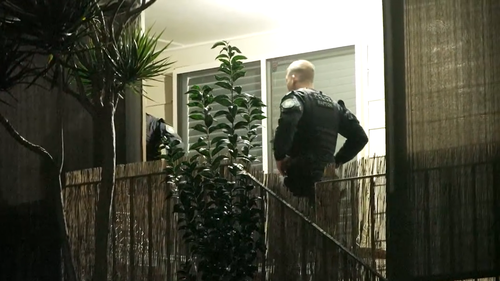 An alleged Rebels bikie member has been charged after police uncovered a video of a caged cat being fatally shot at point-blank range on his phone.