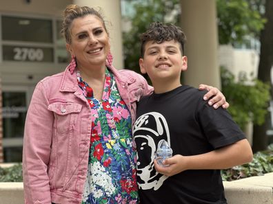 Isaiah Subia with mum Stephanie, accepting the Methodist Mansfield Medical Center's Community Health Hero Award for saving her life after she suffered a stroke.