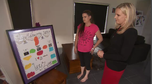 Janelle Saunders looks at a school project completed by Zoe. (9NEWS)
