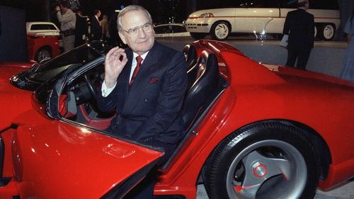 Chrysler Corporation Chairman Lee Iacocca sits in a 1990 Dodge Viper sports car.