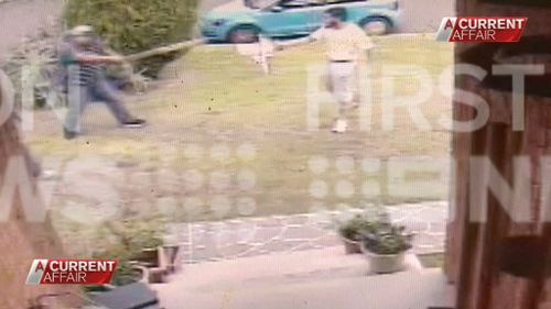 Three men are shown fighting the alleged attacker on the lawn. (9NEWS)