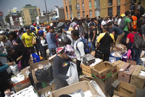 Volunteers prepare food and water for emergency personnel searching for survivors in Mexico City. (AP)