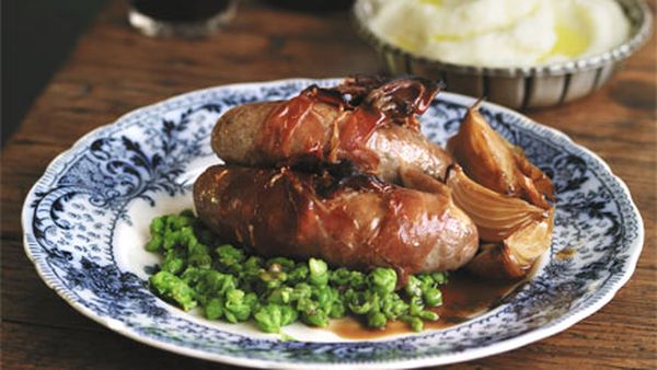 Bangers and mash with onion gravy and mashed peas