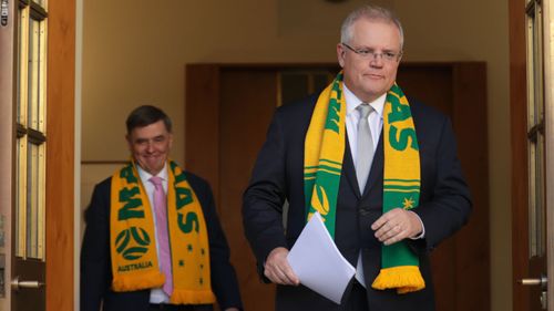 Scott Morrison and Brendan Murphy in Matildas scarves (Alex Ellinghausen).