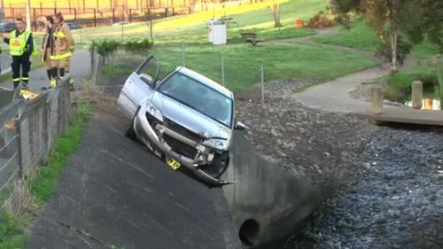 Woman rescued from car hanging over storm water drain in Sydney