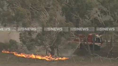 Firefighters are battling spot fires that have flared up away from the main blaze. (9NEWS)