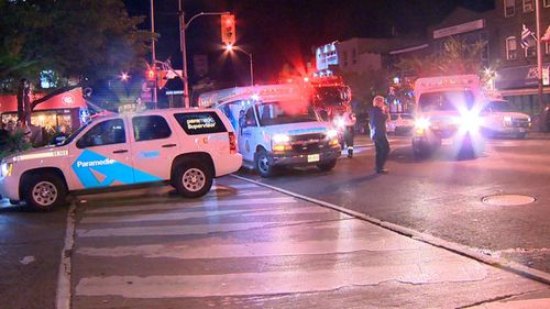 Police and paramedics attend victims at the scene of the alleged shooting. Picture: JeremyGlobalTV