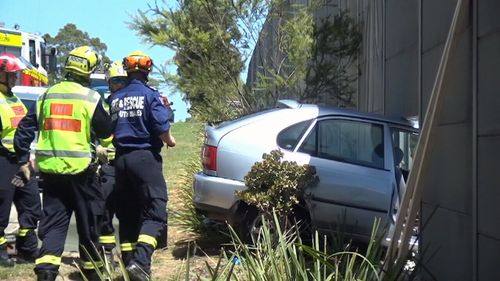 Fire &amp; Rescue NSW worked to secure the car and prevent it from falling onto the railway line. (9NEWS)
