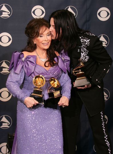 Loretta Lyne and Jack White pose backstage with their awards for Best Country Collaboration With Vocals during the 47th Annual Grammy Awards at the Staples Center February 13, 2005.