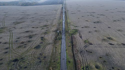 Artillery craters are seen in the field from an arial view in the recently liberated area of Kharkiv region, Ukraine, Friday, Sept. 30, 2022. (AP Photo/Evgeniy Maloletka)