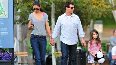 Tom Cruise, Katie Holmes and Suri Cruise walk together on October 8, 2011.