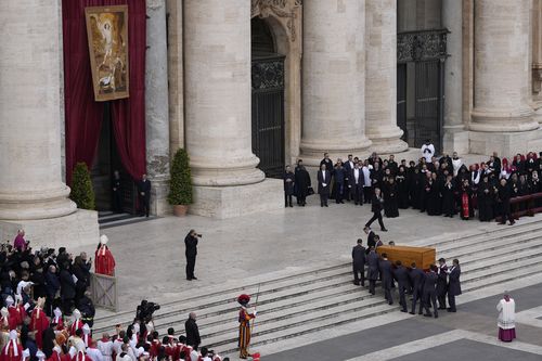 The coffin of late Pope Emeritus Benedict XVI is carried away after a funeral mass in St. Peter's Square at the Vatican, Thursday, Jan. 5, 2023 