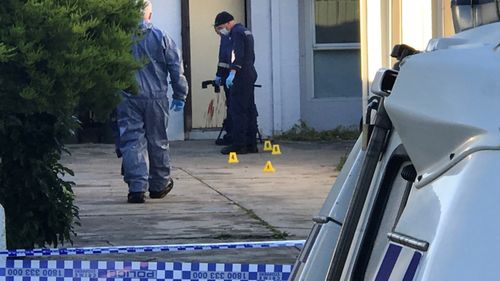 Blood could be seen smeared on the front door of the home.