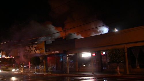 An abandoned Foodworks supermarket was found alight and billowing plumes of smoke. (9NEWS)