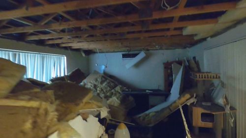 The father and son were trapped under a collapsed ceiling as strong winds battered their home in Western Australia.