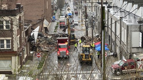 Emergency responders and heavy equipment are seen at the site of a deadly explosion at a chocolate factory in West Reading, Pennsylvania, Saturday, March 25. (AP Photo/Michael Rubinkam)