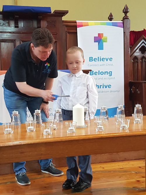 Jack and Pastor Becky lighting candles during church.