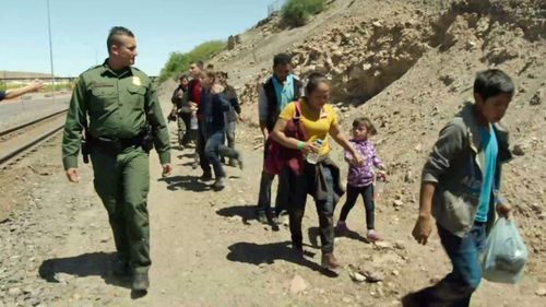 US Border Patrol agent Carlos Antunez arresting immigrants crossing the border into the US illegally.