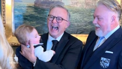 Prime Minister Anthony Albanese holds Otto, son of radio personality Kyle Sandilands, at his star-studded wedding.