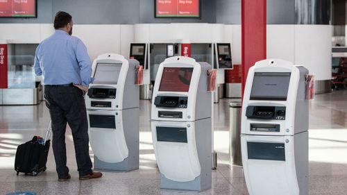 A lone passenger checking in to a flight at Sydney Airport.