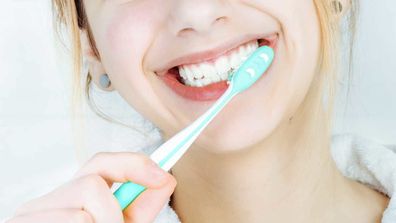 Close up of woman brushing teeth