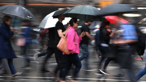 The umbrellas were out in the CBD today as Sydney copped a drenching. (AAP)