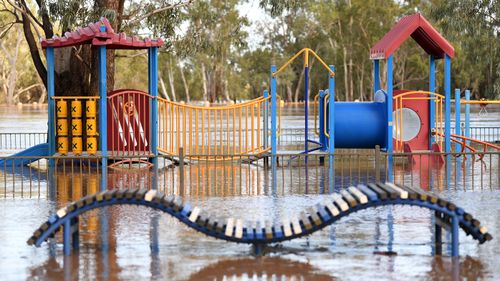 A playground is surrounded by flood water in St George, south-western Queensland, Wednesday, February 26, 2020. The Balonne river is expected to break its banks and peak over 12 metres on Thursday, causing floods