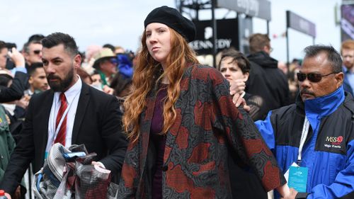 A woman was escorted from Flemington. (AAP)