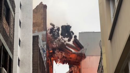 Firefighters say a massive blaze that engulfed a seven-storey building in central Sydney has now been contained.