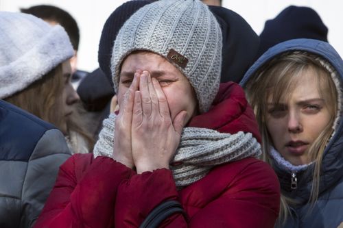 Mourners have gathered in huge numbers at the plaza outside the burnt-out mall, while others lined up to donate blood to the injured. (AAP)