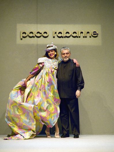 Franco-Spanish fashion designer Paco Rabanne poses with a model on January 30, 1991 in Paris, France.
