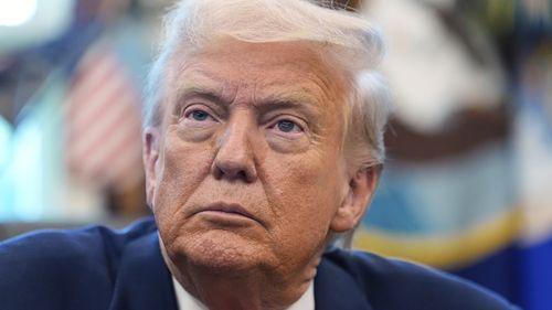 President Donald Trump listens during an event in the Oval Office to mark the 90th anniversary of the Social Security Act, Thursday, Aug. 14, 2025, in Washington. (AP Photo/Alex Brandon)