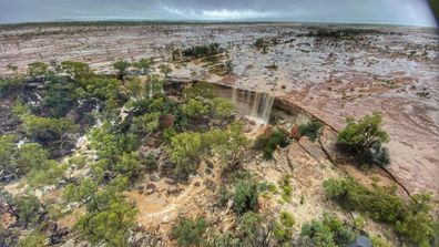 An employee of the Australian Museum of the Age of Dinosaurs near Winton in inland Queensland has captured incredible scenes from the air as a deluge rages across the state. 