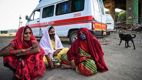 Women mourn for a relative at a mass crematorium site on the banks of the Ganges river in Allahabad, India.