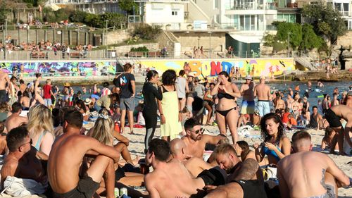 Beachgoers are seen at Bondi Beach despite the threat of Coronavirus (COVID-19) in Sydney, Friday, March 20, 2020.