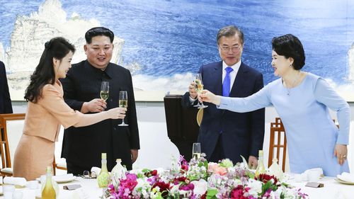 President Moon Jae-in and his wife Kim Jung Sook alongside Kim Jong-un and his wife Ri Sol Ju at a banquet at the House of Peace in the border village. (AAP)