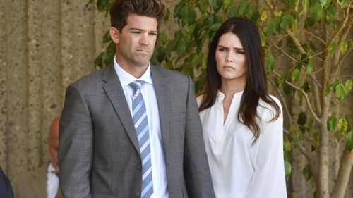 Dr. Grant Robicheaux and his girlfriend Cerissa Riley listen during a news conference by their lawyer Philip Kent Cohen in Newport Beach, California.