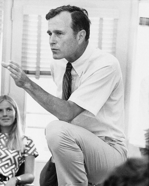 George H.W. Bush, talks with a group of young people at a rally in Houston, Texas in 1970.