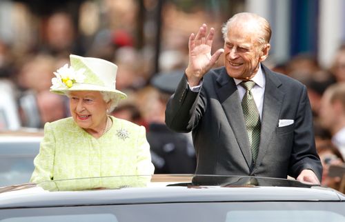 Queen Elizabeth II and Prince Philip, Duke of Edinburgh travel through Windsor in an open top Range Rover after her 90th Birthday Walkabout on April 21, 2016 in Windsor, England. 