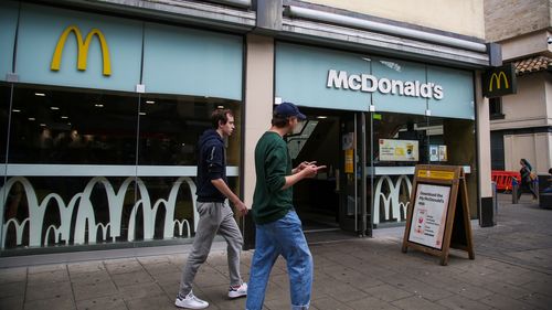 BRISTOL, UNITED KINGDOM - 2021/08/16: Men walk past a branch of McDonald's in Bristol. (Photo by Dinendra Haria/SOPA Images/LightRocket via Getty Images)