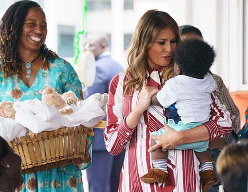 First lady Melania Trump holds a baby as she visits Greater Accra Regional Hospital in Accra, Ghana.