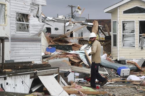 Power company linemen work to restore power after a tornado hit Emerald Isle N.C. as Hurricane Dorian moves up the East coast on Thursday, Sept. 5, 2018.  (AP Photo/Tom Copeland)