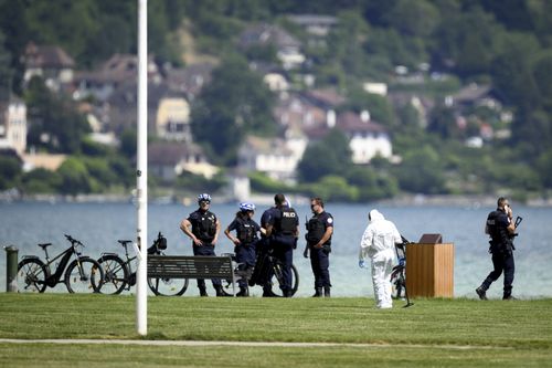 Security forces examine the scene of knife attack in Annecy, French Alps, Thursday, June 8, 2023.  